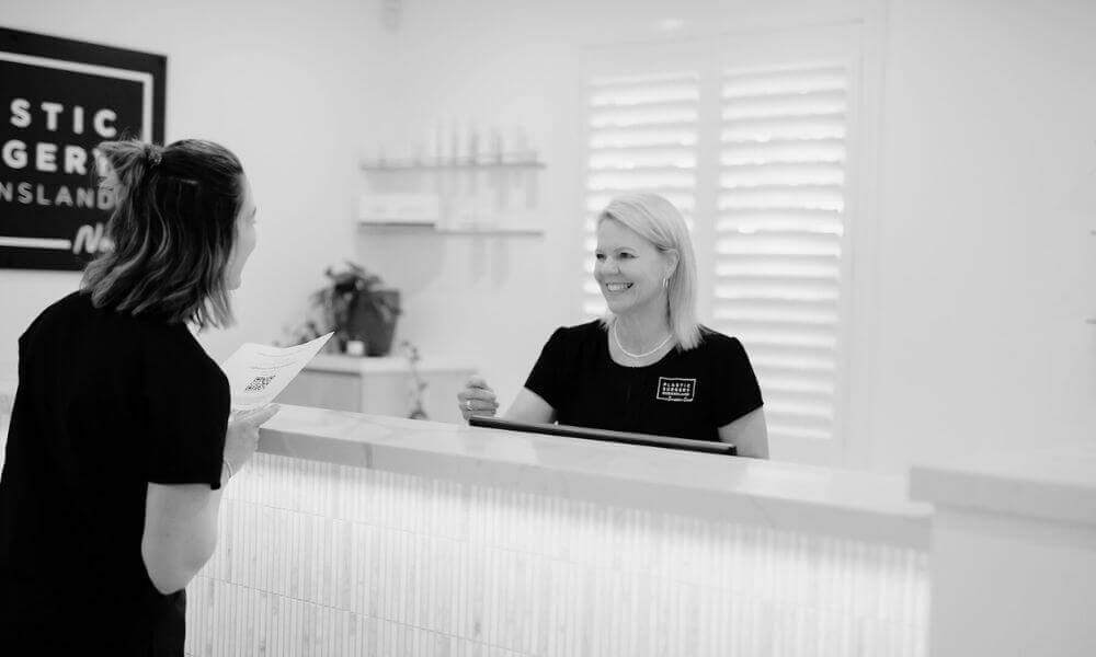 Woman walking into Noosa clinic for her laser facial procedure